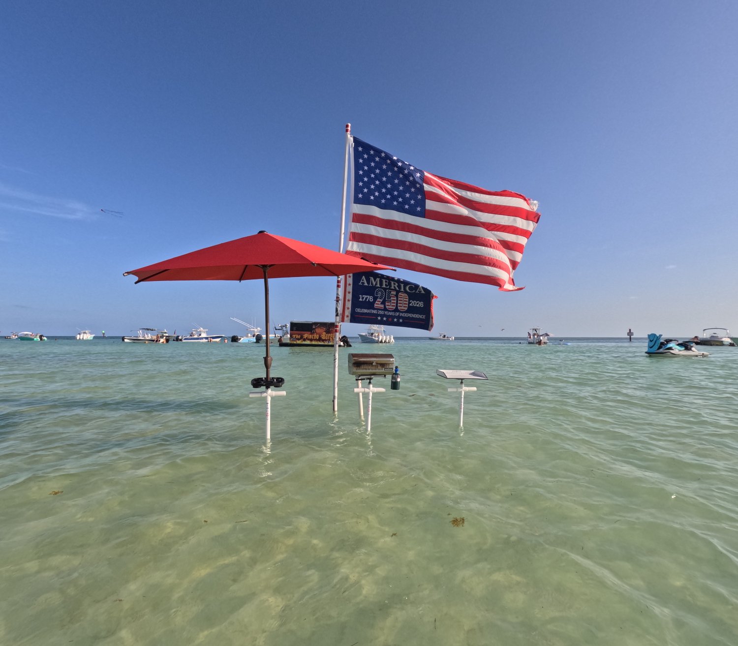 PIPE IT base setup on the sandbar with boats and jet ski
