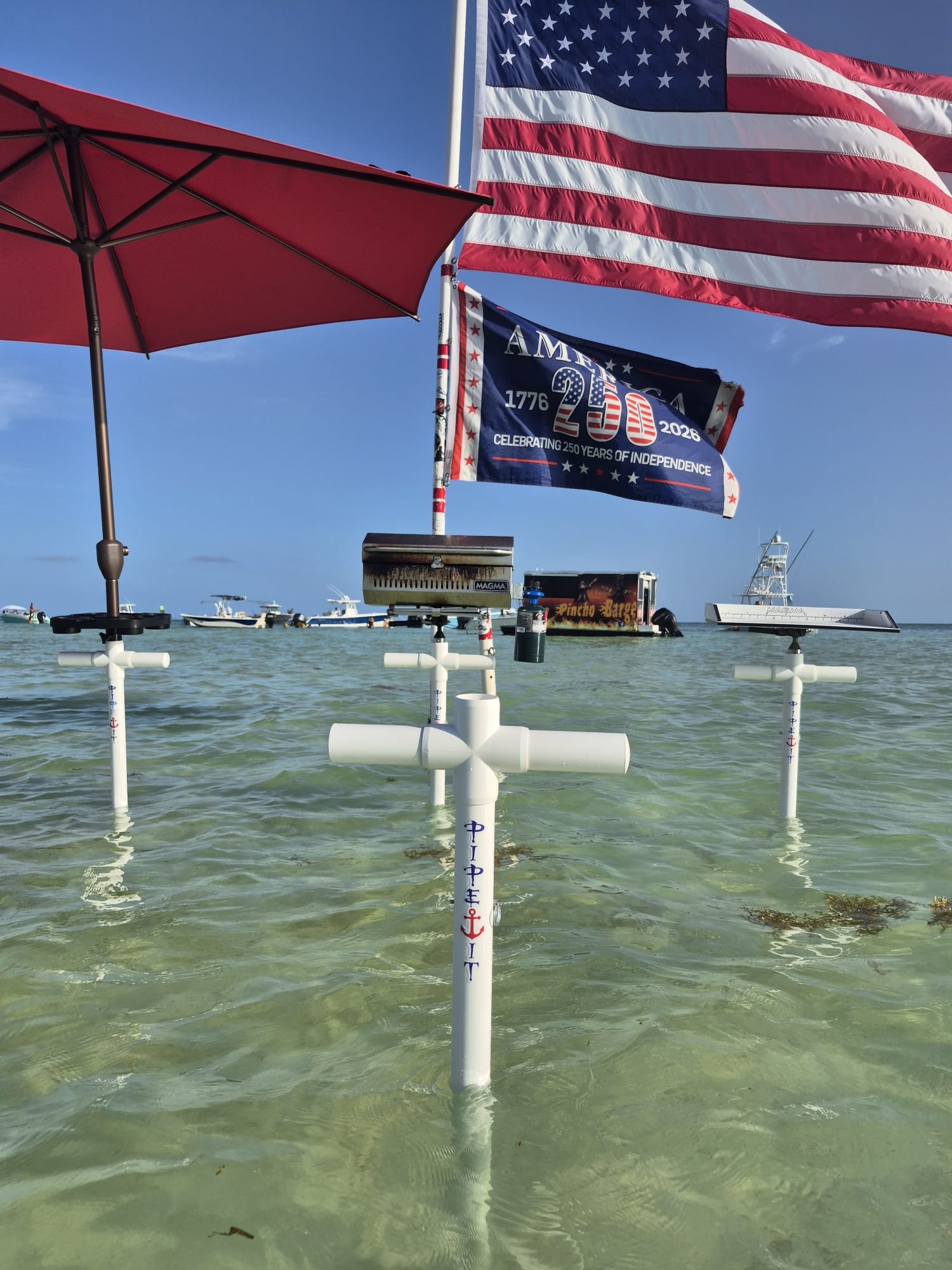 Branded PIPE IT poles planted at the sandbar